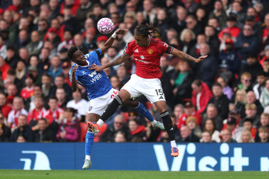 Leny Yoro competes for a header with Simon Adingra during Manchester United v Sunderland at Old Trafford
