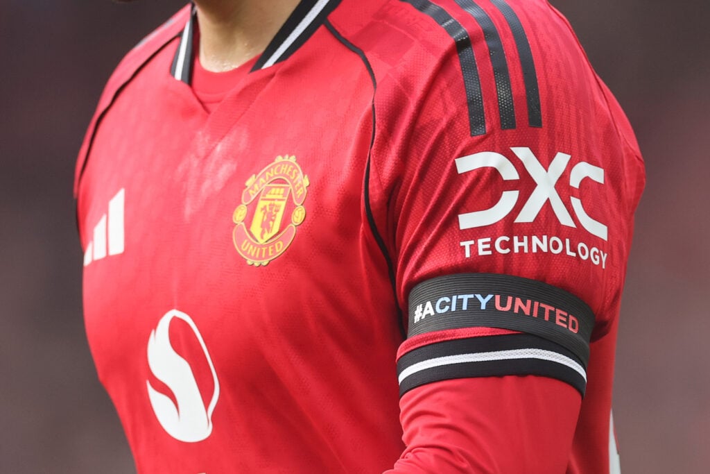 A detailed view of the Manchester United home shirt, with Adidas, Snapdragon and DXC Technology logos prominent