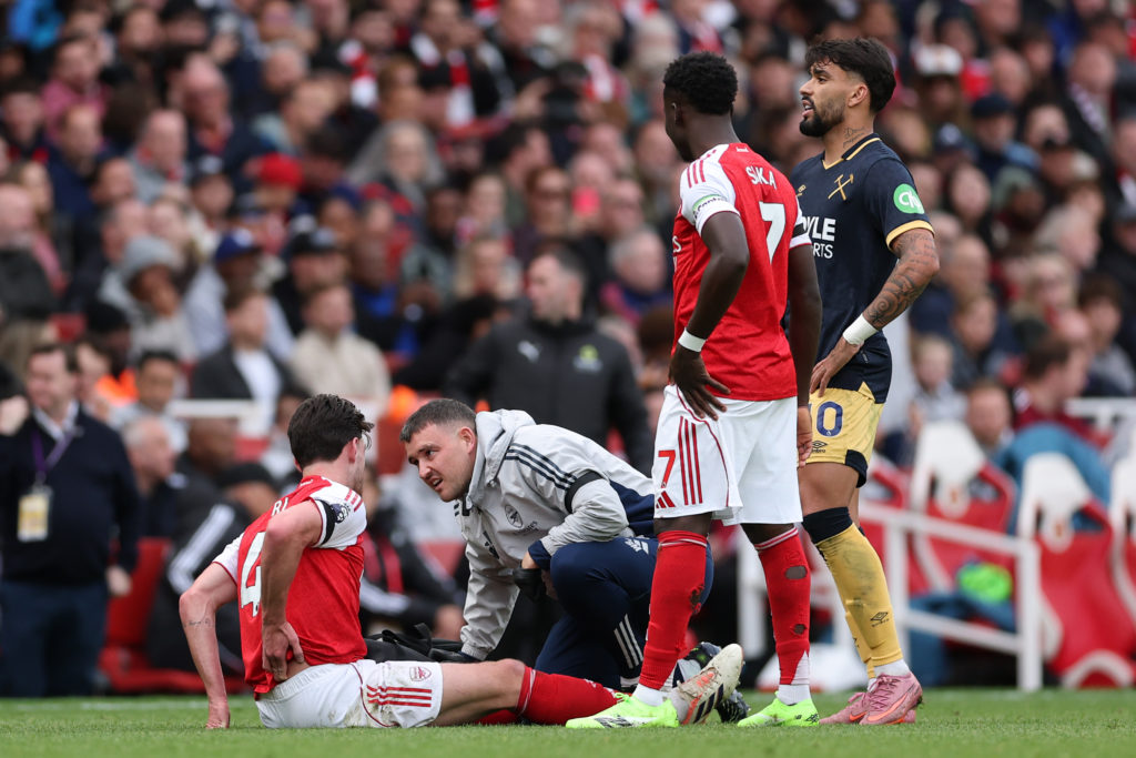 Declan Rice holds his back during Arsenal vs West Ham