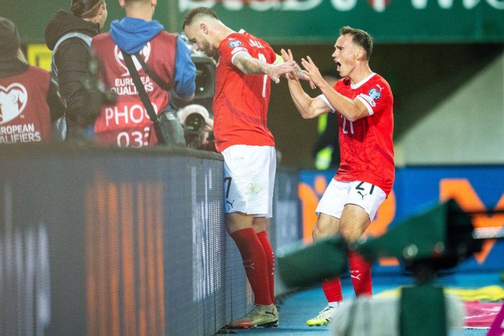 Marko Arnautovic (L) celebrates with Austria's forward #21 Nikolaus Wurmbrand