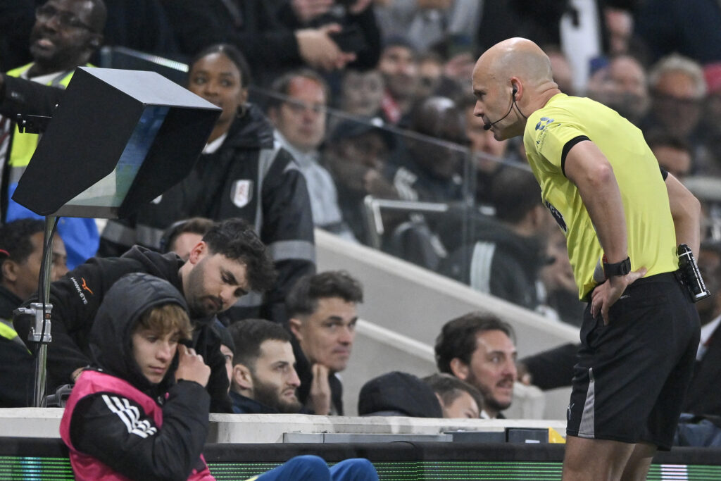 Anthony Taylor looks at the VAR during Fulham vs Arsenal