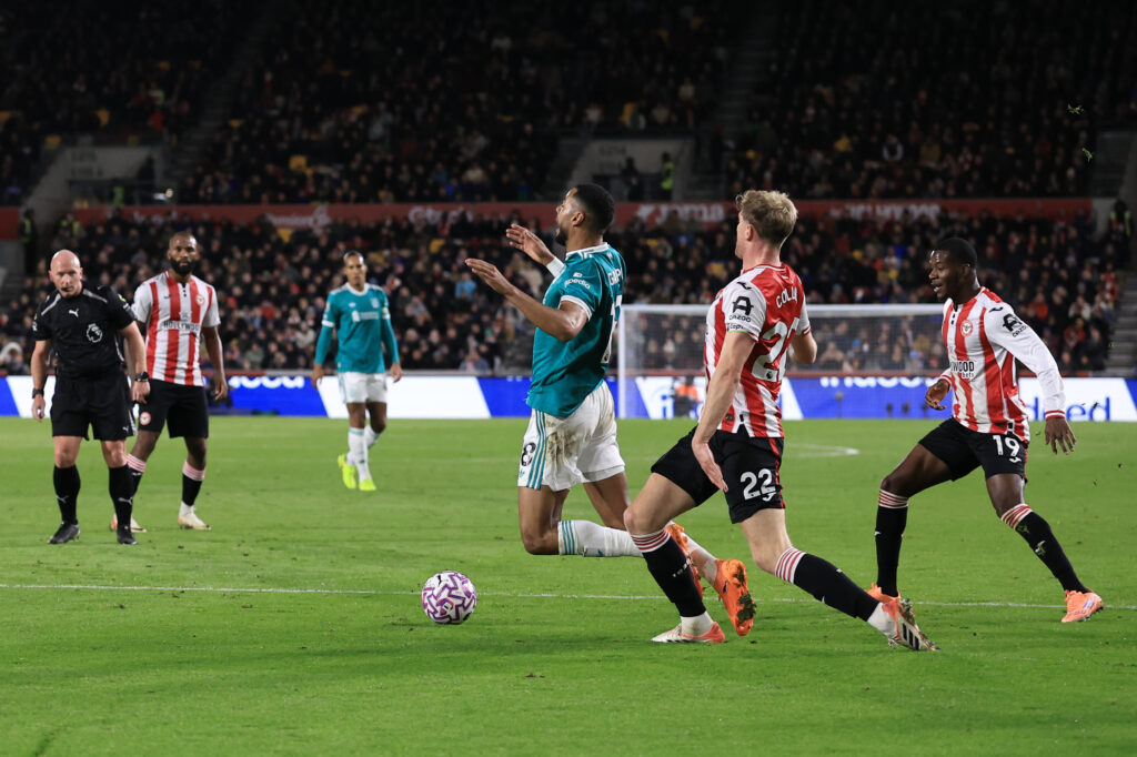 Referee Simon Hooper looks on as and waves away call for a penalty as Cody Gakpo of Liverpool goes down under pressure from Nathan Collins of Brentford during the Premier League match between Brentford and Liverpool