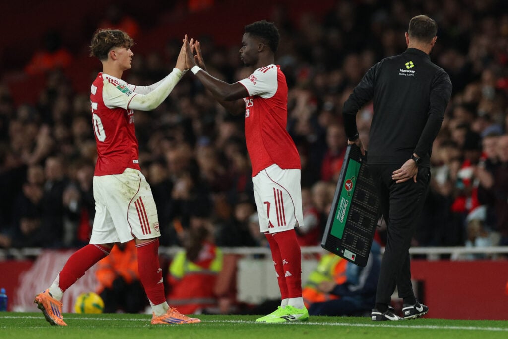 Max Dowman and Bukayo Saka look on during Arsenal vs Brighton