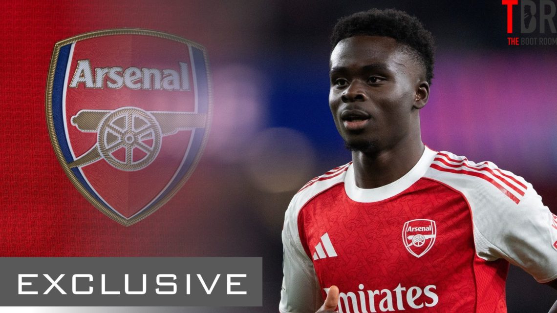 Bukayo Saka looks on alongside an Arsenal badge and an exclusive TBR Football banner