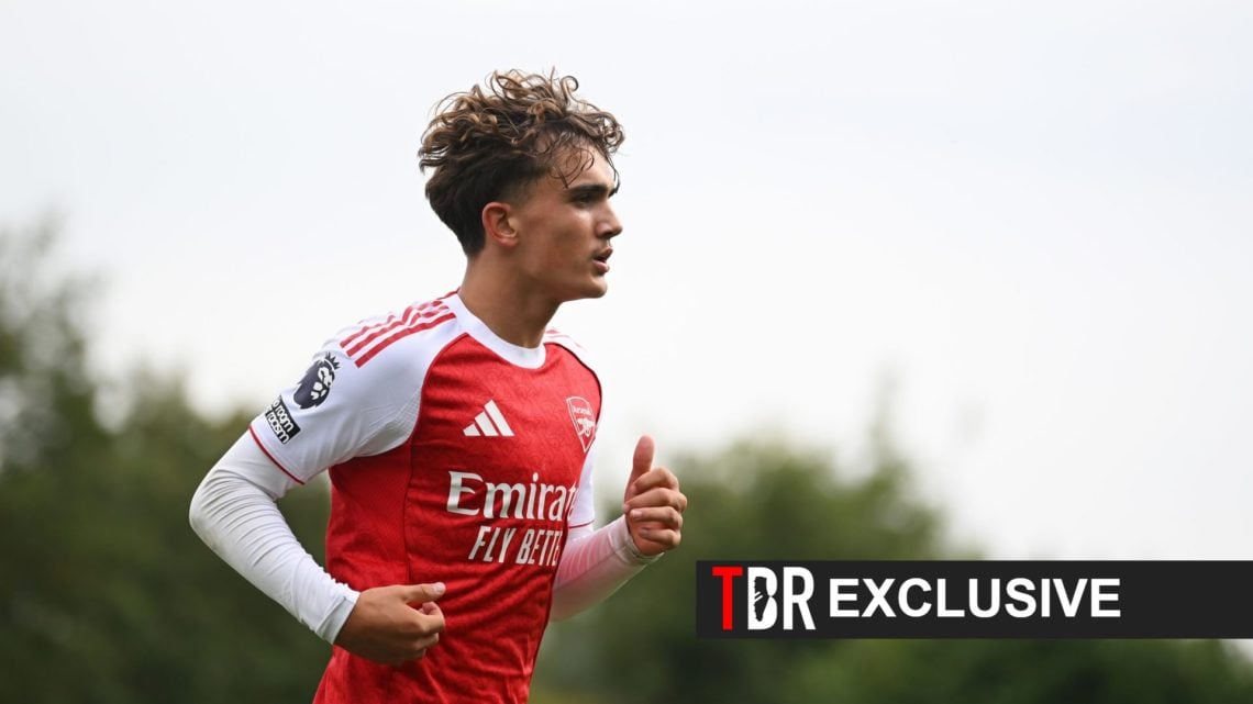 Max Dowman looks on during an Arsenal match alongside an excusive banner and the TBR Football logo