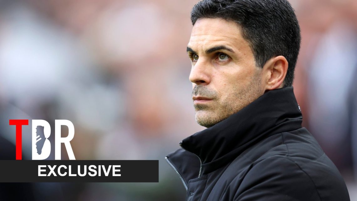 Mikel Arteta looks on during an Arsenal match alongside a TBR Football Exclusive banner