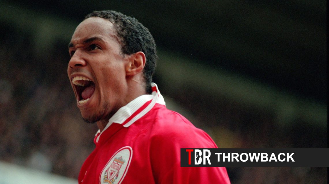 Paul Ince celebrates during a Liverpool game alongside a TBR Football logo and throwback banner