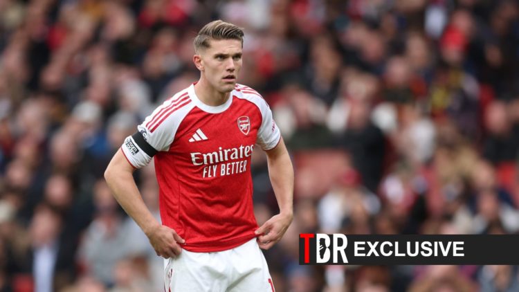 Viktor Gyokeres looks on during an Arsenal match alongside an exclusive banner and the TBR Football logo