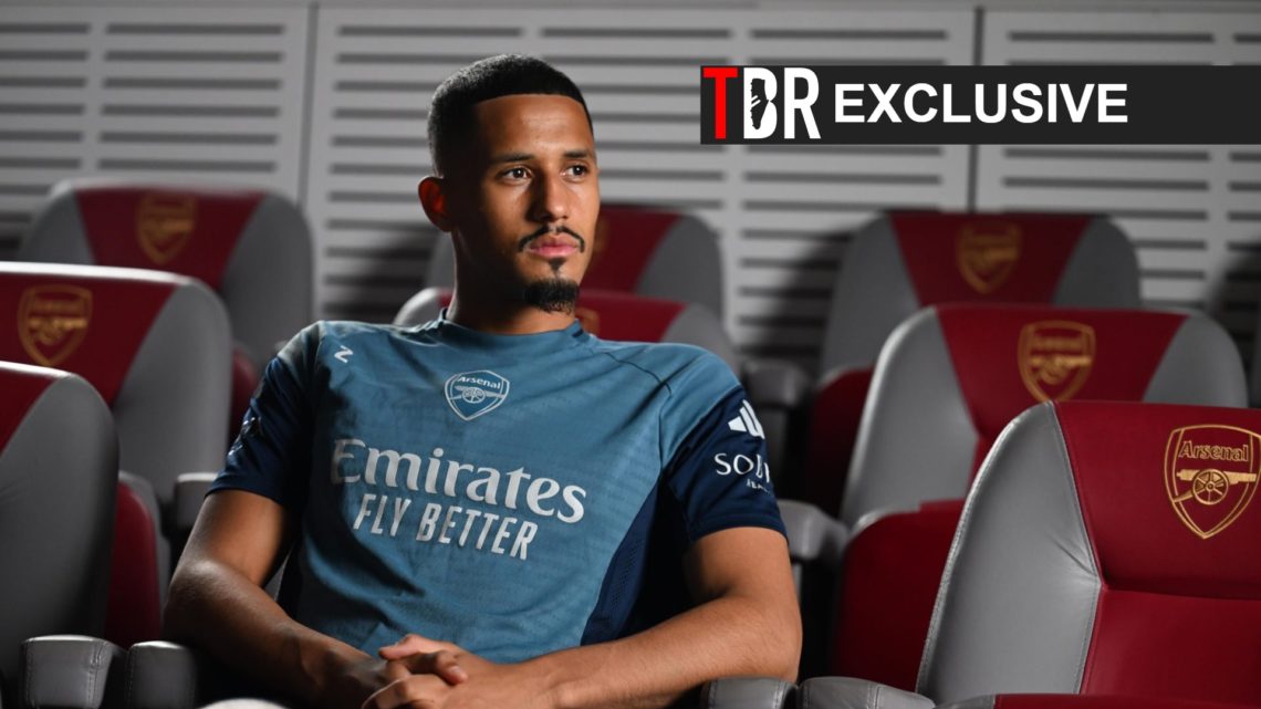William Saliba looks on during an Arsenal interview alongside an exclusive banner from TBR Football