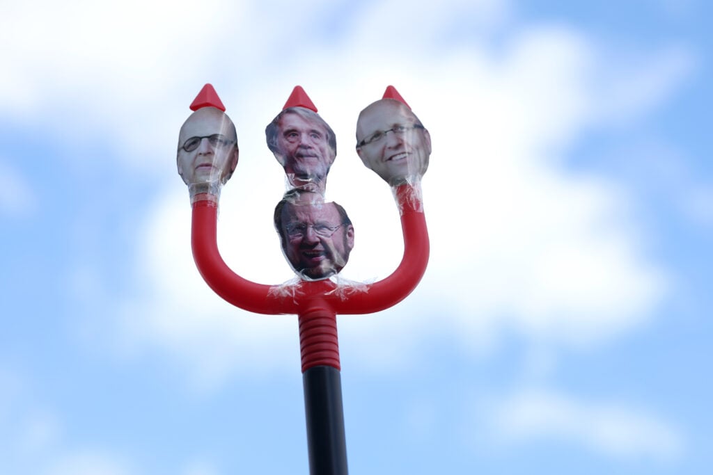 Manchester United fans protest, with trident featuring Glazer and Sir Jim Ratcliffe's faces