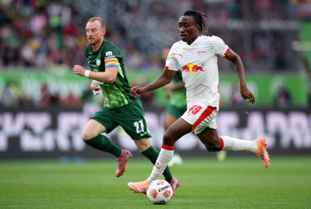 Yan Diomande runs with the ball during Wolfsburg vs RB Leipzig