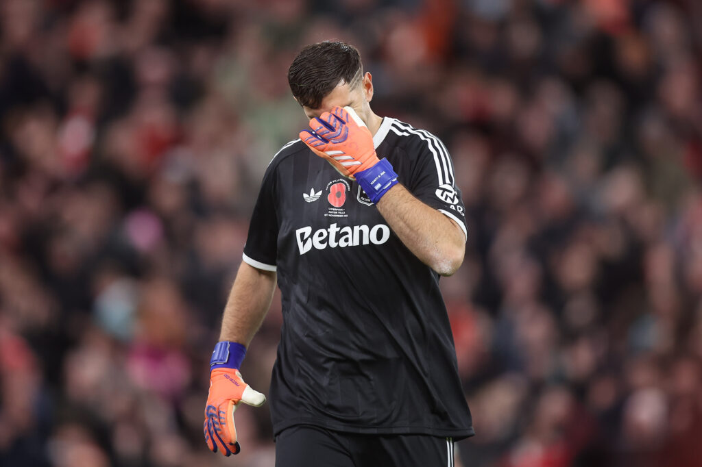 Emiliano Martinez of Aston Villa looks dejected after conceding vs Liverpool
